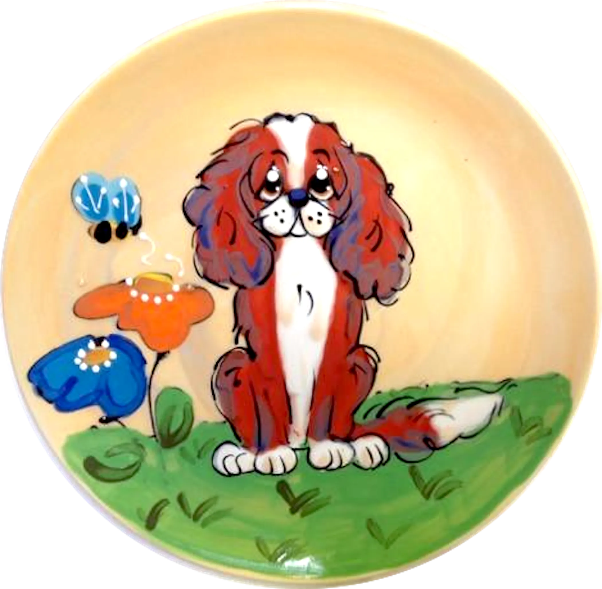 King Charles Cavalier sitting in flower garden