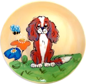 King Charles Cavalier sitting in flower garden